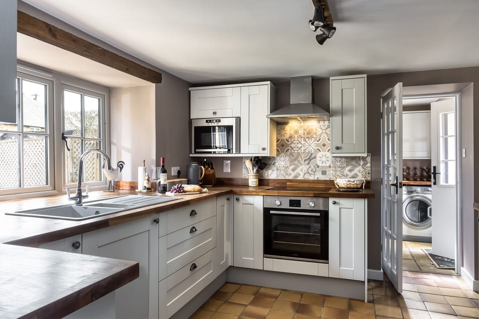 The kitchen is well equipped and boasts integrated appliances, wooden worktops and a quarry tiled floor