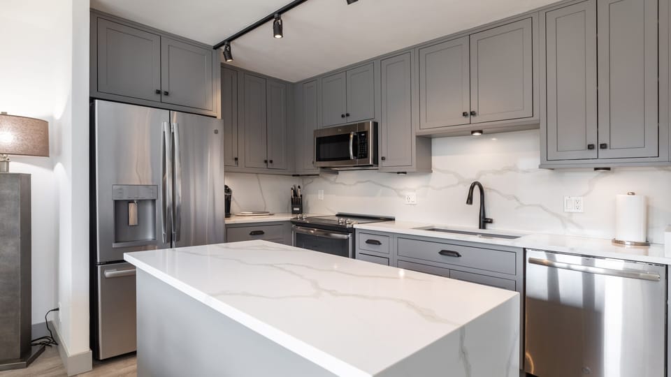 Fully stocked kitchen with marble island
