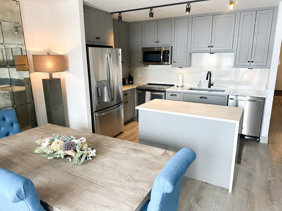 Fully stocked kitchen and dining area with Restoration Hardware furnishings 