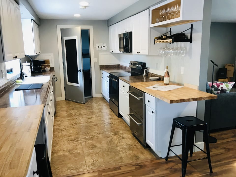 Fully stocked kitchen • Bar Area • Natural light • Farmhouse sink • Plants