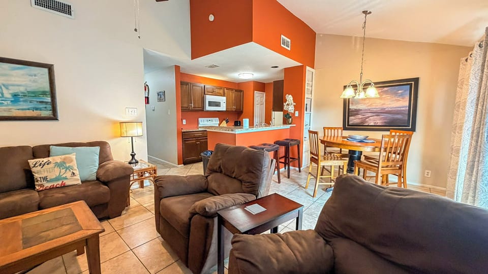 Sink into plush seating and enjoy your morning coffee in this warm, open-concept space where kitchen, dining, and living areas flow together perfectly.