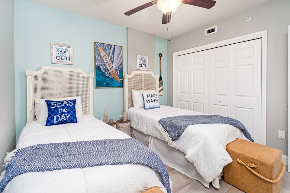 Two twin beds and a mounted TV