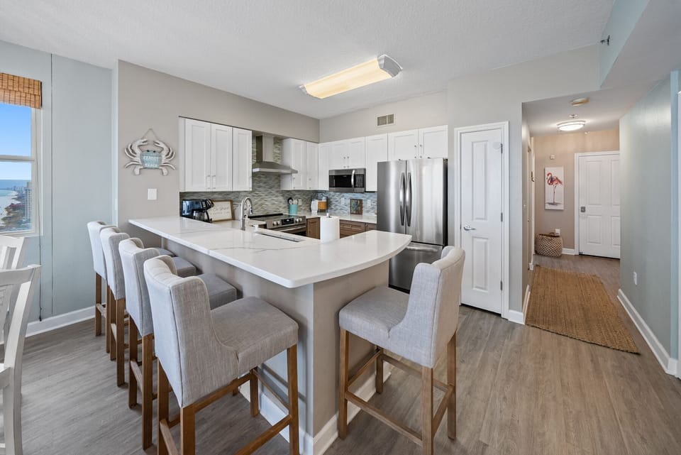 Luxury kitchen with quartz countertops and newer stainless appliances