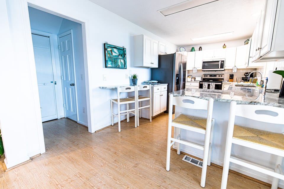 Updated fully furnished kitchen with new appliances and granite countertops