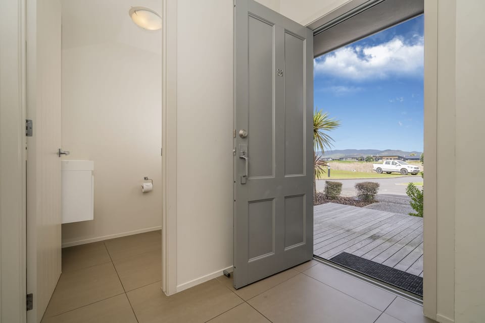 Front door, and secondary toilet. Looking out to parking and the golf course.