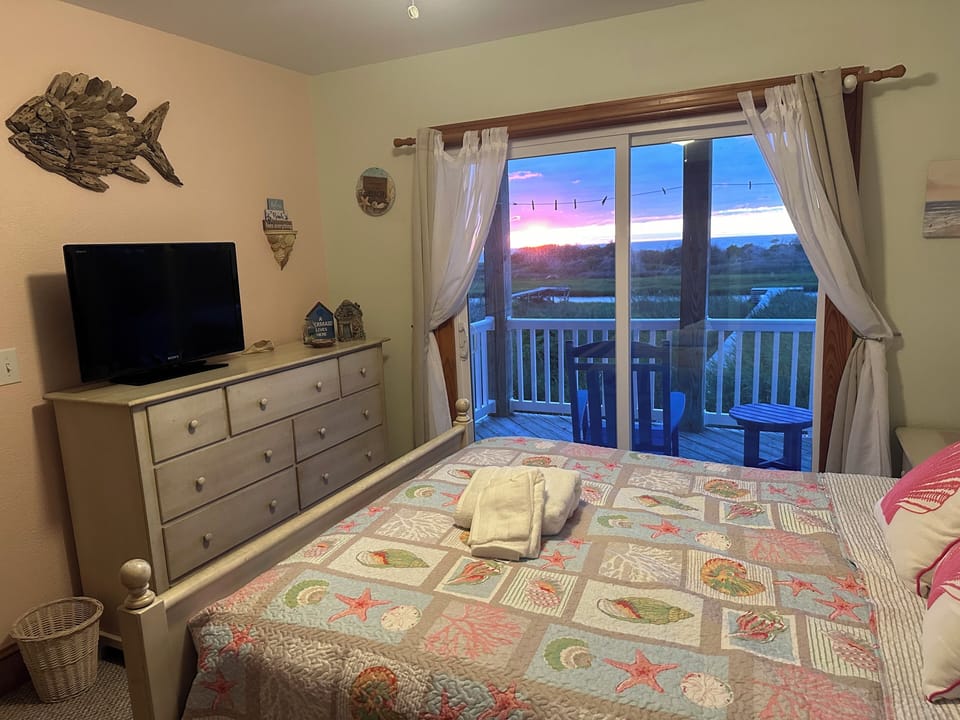 2nd-floor master bedroom suite with a queen-sized bed with views of the sound.