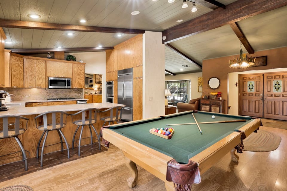 Bright entertainment space featuring a pool table, inviting guests to enjoy friendly competition and memorable gatherings indoors