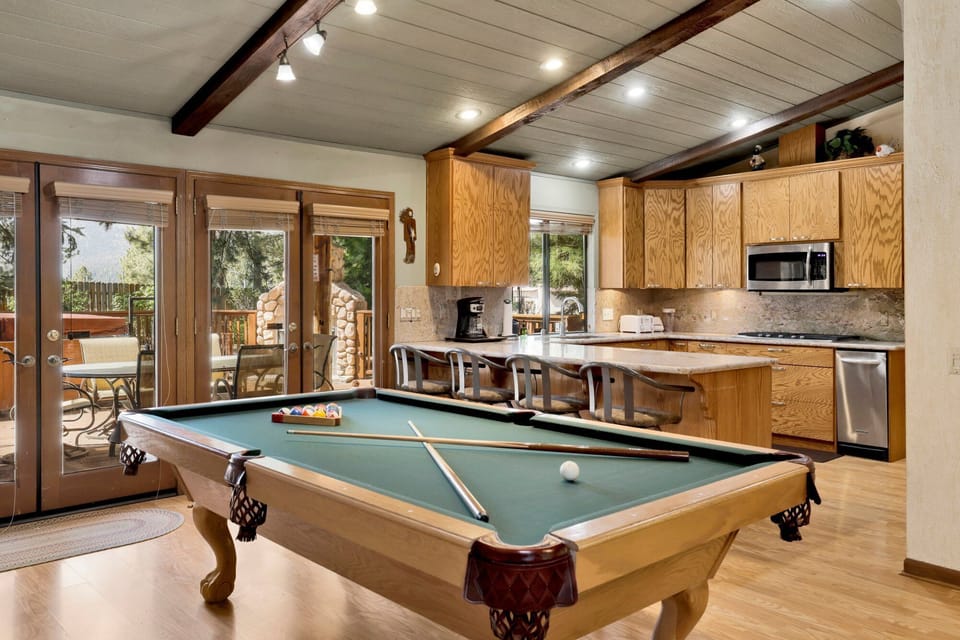Spacious game room with billiards table and cozy seating, perfect for lively matches, family fun, and relaxed evenings together