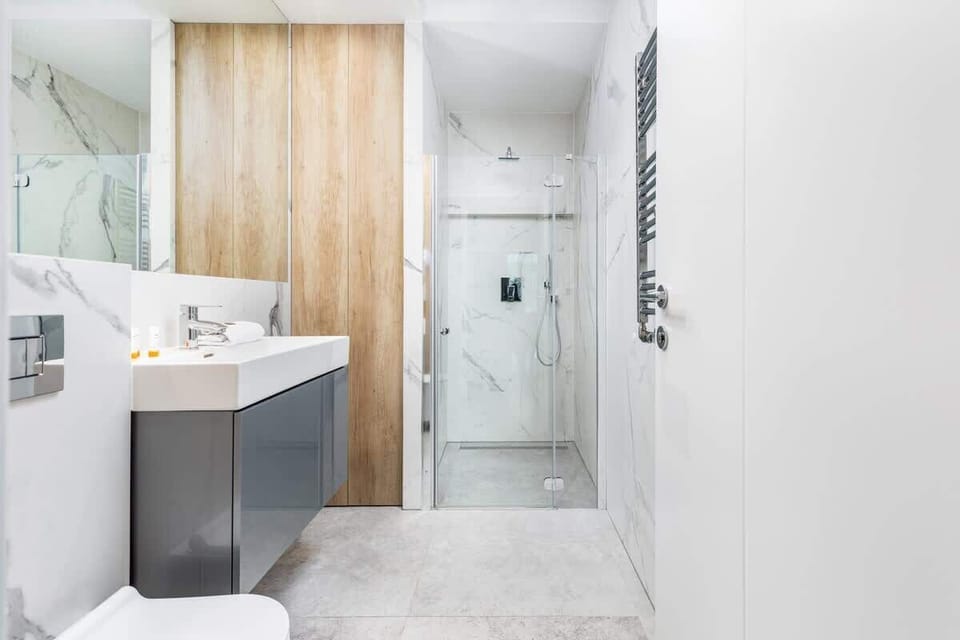 Bathroom with washing machine and towels. 