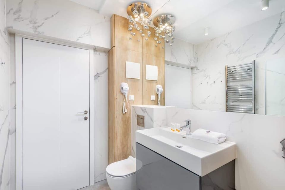Bright bathroom with washing machine and shower cabin. 
