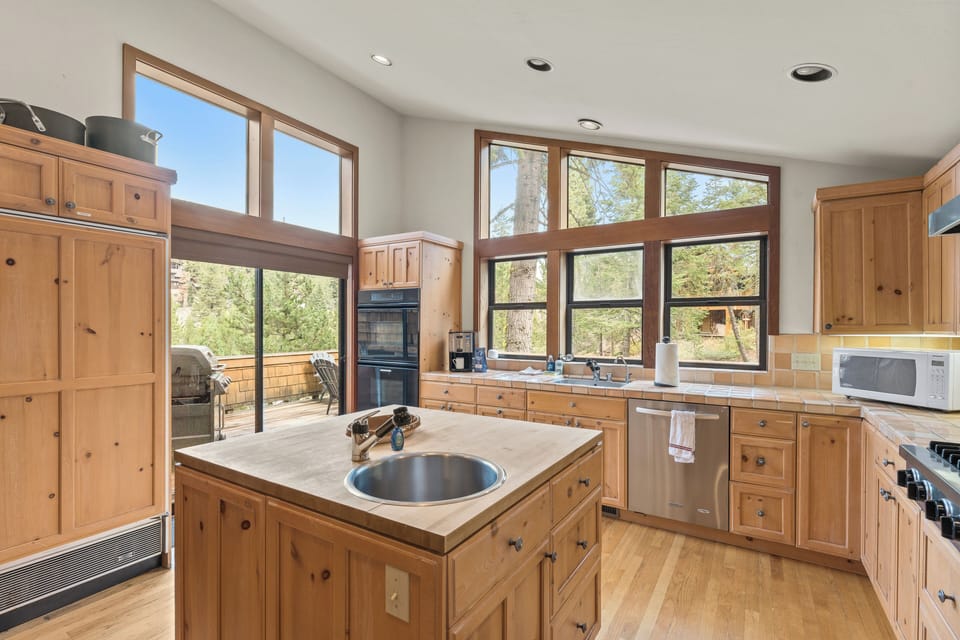 Chef's kitchen fully equipped for culinary adventures with deck access. 