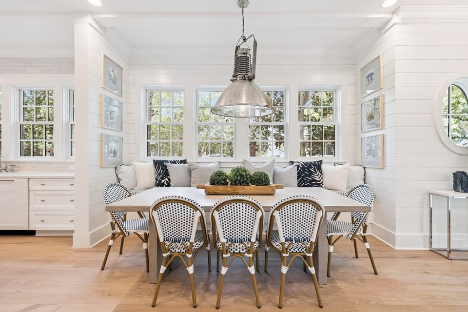 Gather around this bright dining space where natural light streams through windows, creating the perfect spot for memorable meals together.
