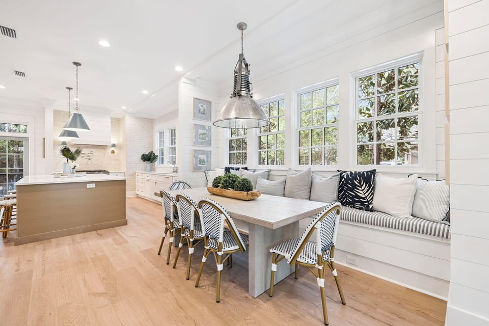 Step into your bright, open living space where kitchen flows seamlessly into dining. Natural light floods through oversized windows as you gather around the elegant table.