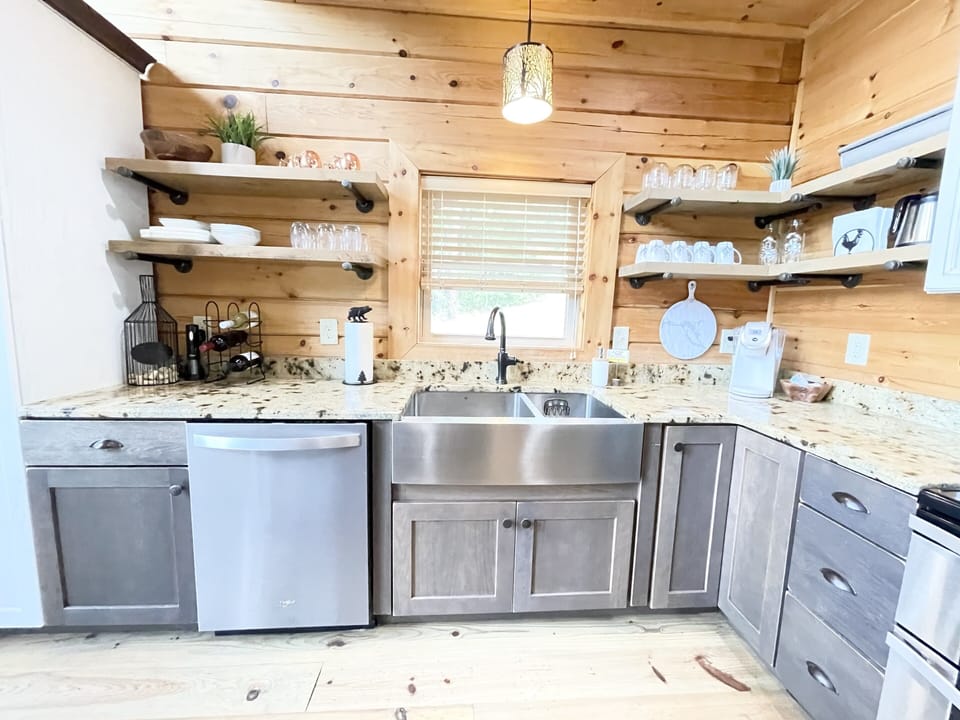 You’ll love the huge sink, stainless steel appliances, and floating shelves! 