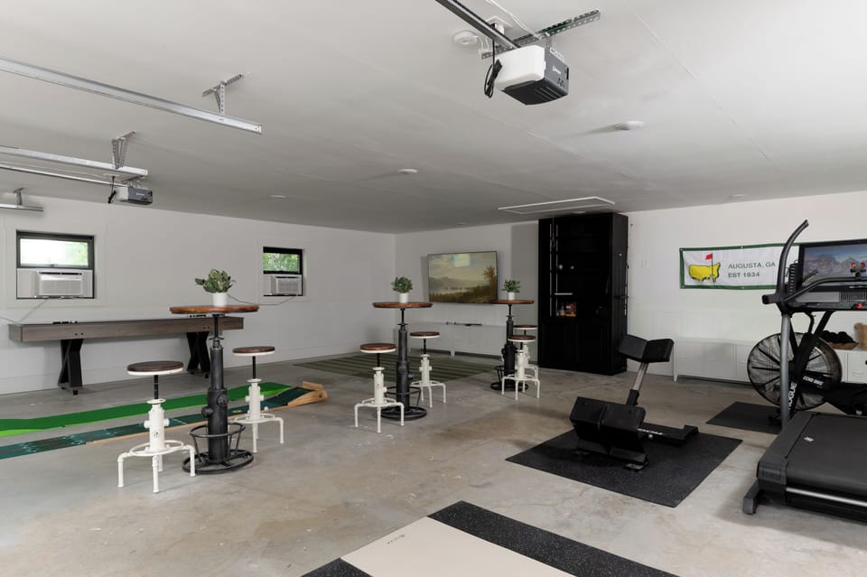 Golf simulator and private gym for indoor entertainment.