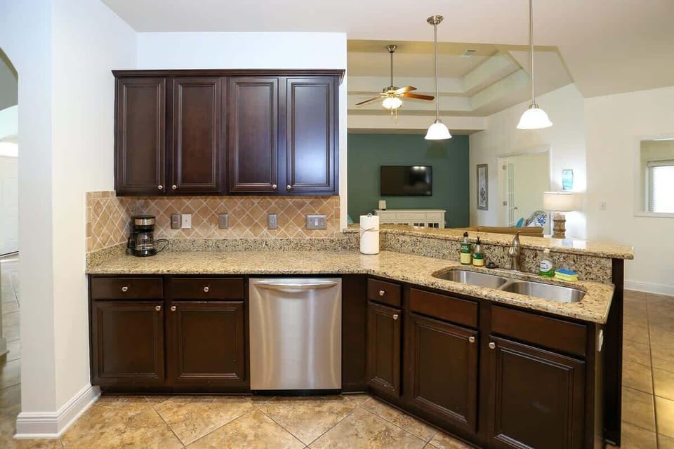 - Keep the conversation flowing with this open kitchen layout that looks right into the living room - Granite countertops, double sink, & sleek dishwasher make cleanup a breeze - Brew your morning coffee or prep dinner while staying connected to the