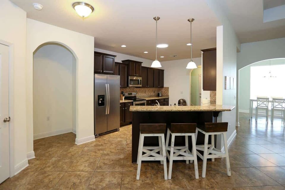 - Unwind in this stylish kitchen with granite countertops & stainless steel appliances - Bar seating for three makes it easy to sip, or keep the chef company - Everything you need is right here, from coffee to cocktails, this kitchen is ready to serv