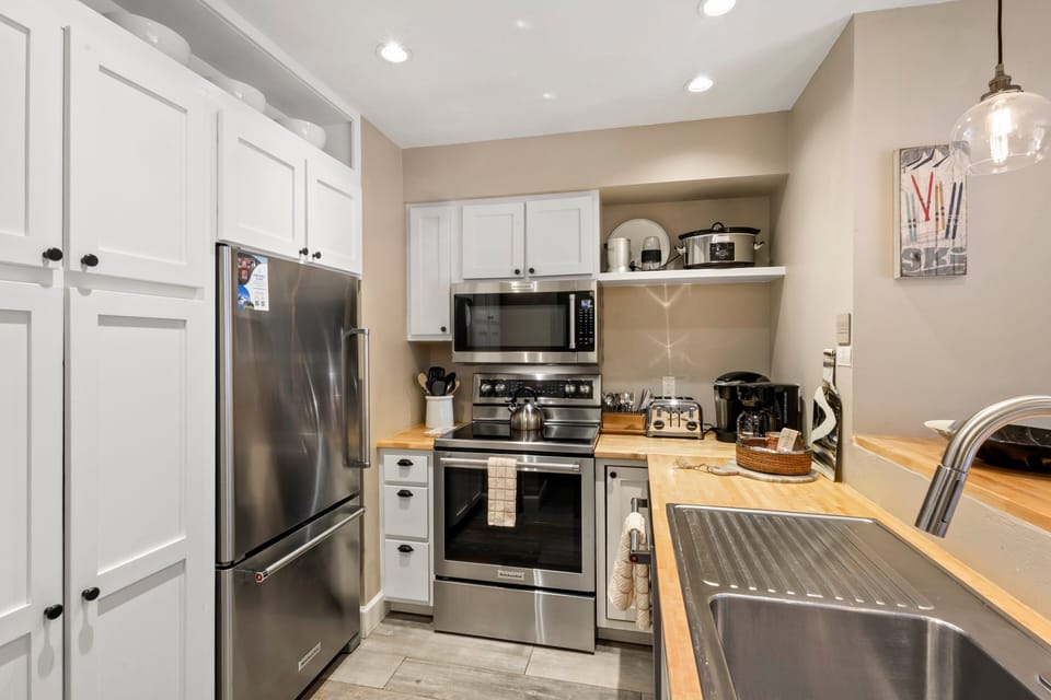 Updated kitchen with stainless steel appliances-electric oven, refrigerator, microwave and dishwasher.