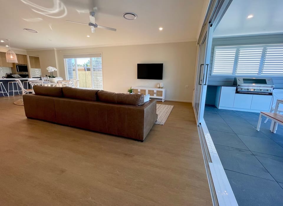 Wide doors connect the living area to the covered alfresco kitchen.