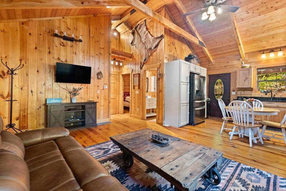Cozy cabin living room with rustic charm and open kitchen