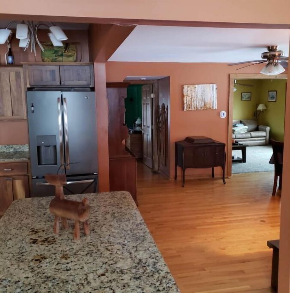 Large fridge and kitchen with center aisle adjoins the common room