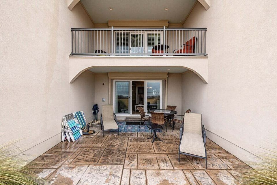 Front view of private patio and second-floor balcony