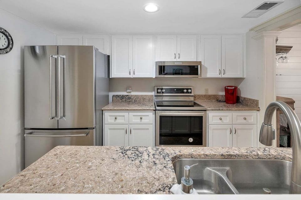 Kitchen with stainless appliances and white cabinets