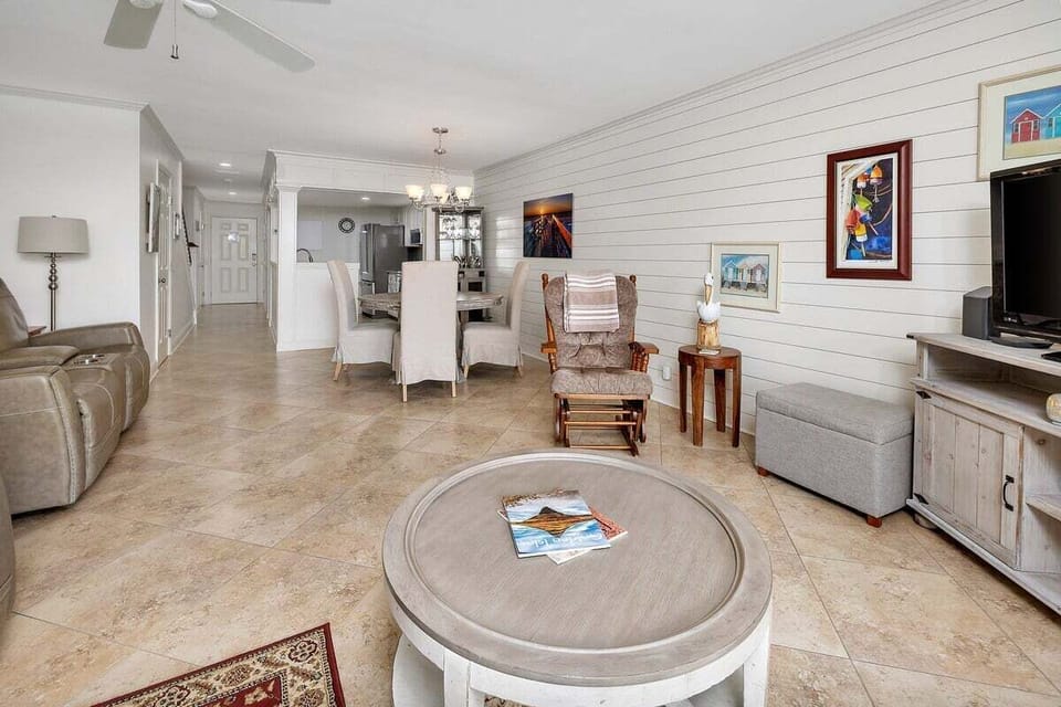 Open-concept living space with coffee table and rocking chair