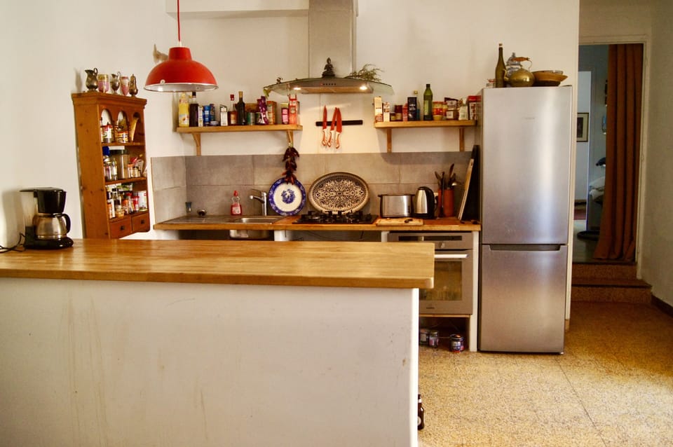 Large fully equipped kitchen with washing machine, dishwasher and dining table for six people. The kitchen has a balcony which looks down on the square below.