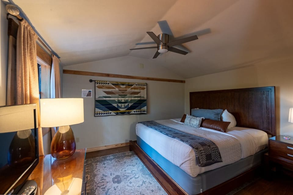 Bedroom with king sized bed and TV