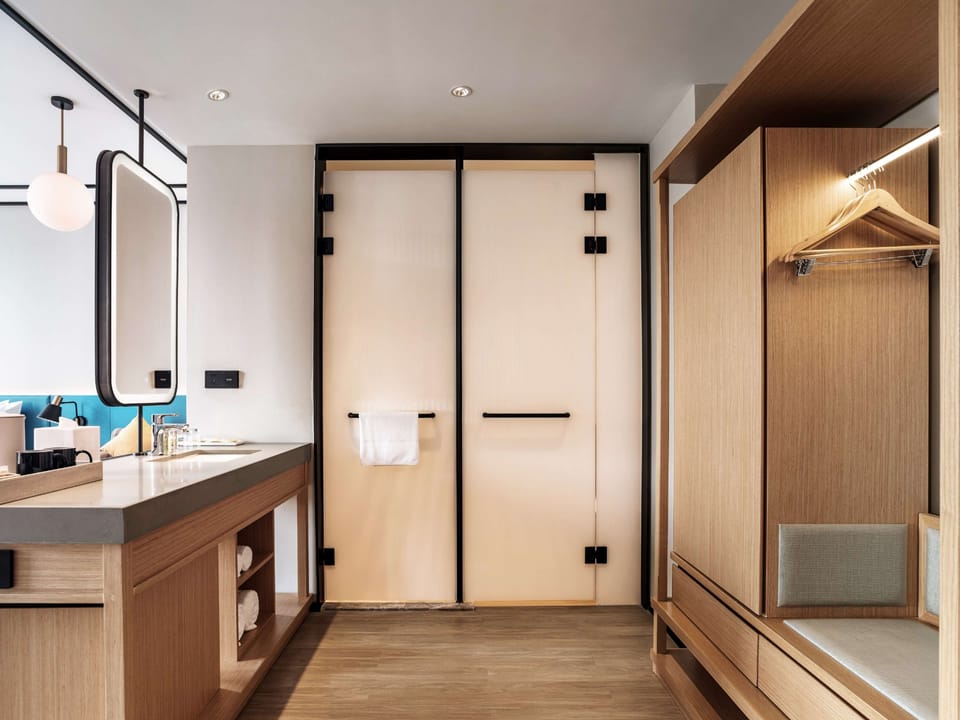 Deluxe Room, 1 King Bed | Bathroom | Shower, rainfall showerhead, designer toiletries, hair dryer