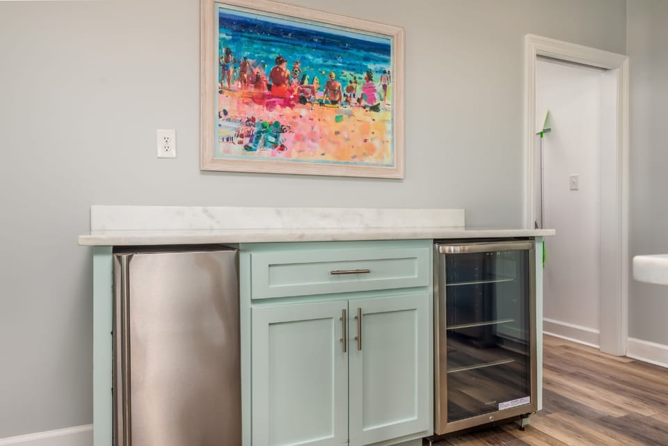 Convenient wet bar with mini fridge, ice maker, and wine storage, perfect for keeping drinks cold and entertaining with ease in this Gulf-front Dauphin Island home.