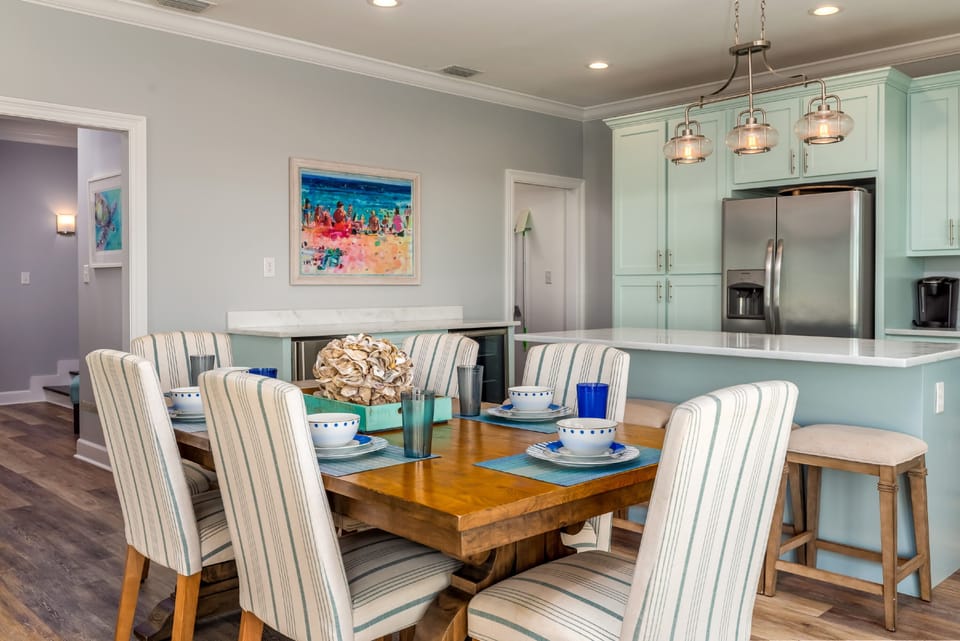 Open dining space with ample seating and beach-inspired design. Ideal for group meals after a day enjoying the Gulf in this Dauphin Island vacation rental.