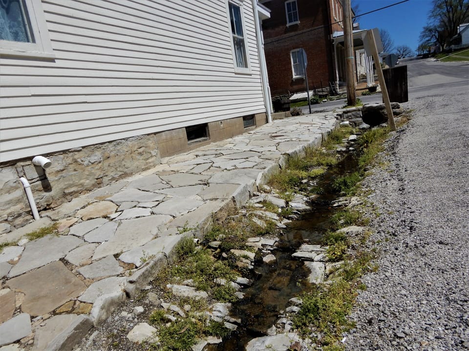 Rock sidewalk and stone gutters leading to Coffee Shop
