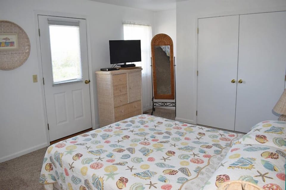 Main Queen Bedroom with Balcony and Private Bath.