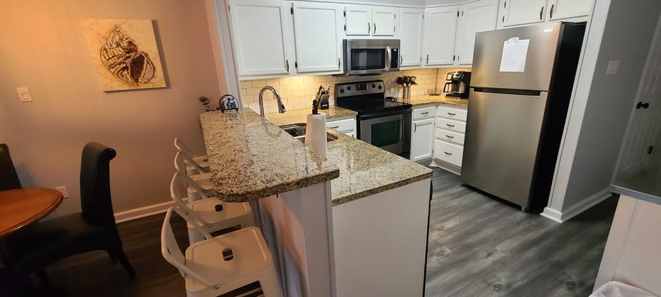 Granite countertops at the bar and in the kitchen.