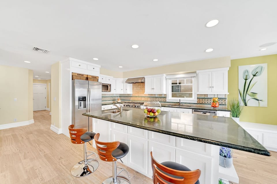 The kitchen comes stocked with dishes, pots/pan, eating and cooking utensils, cookware, bakeware, and large and small appliances.
                