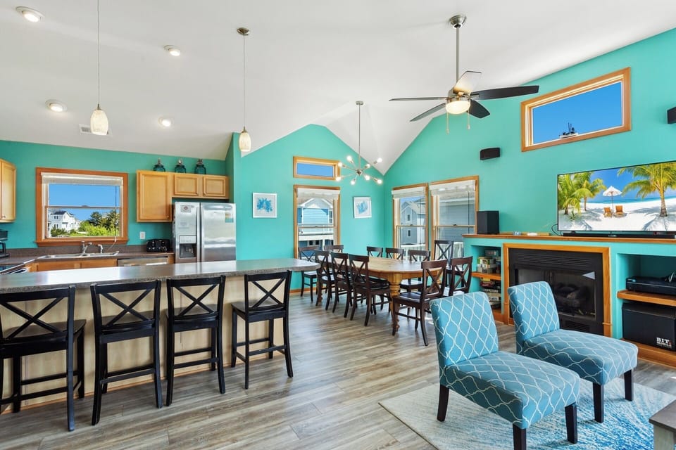 Enjoy time together in the spacious Living Area with High Ceilings and Lots of Light! (*Please note: Fireplace is not for guest use.)