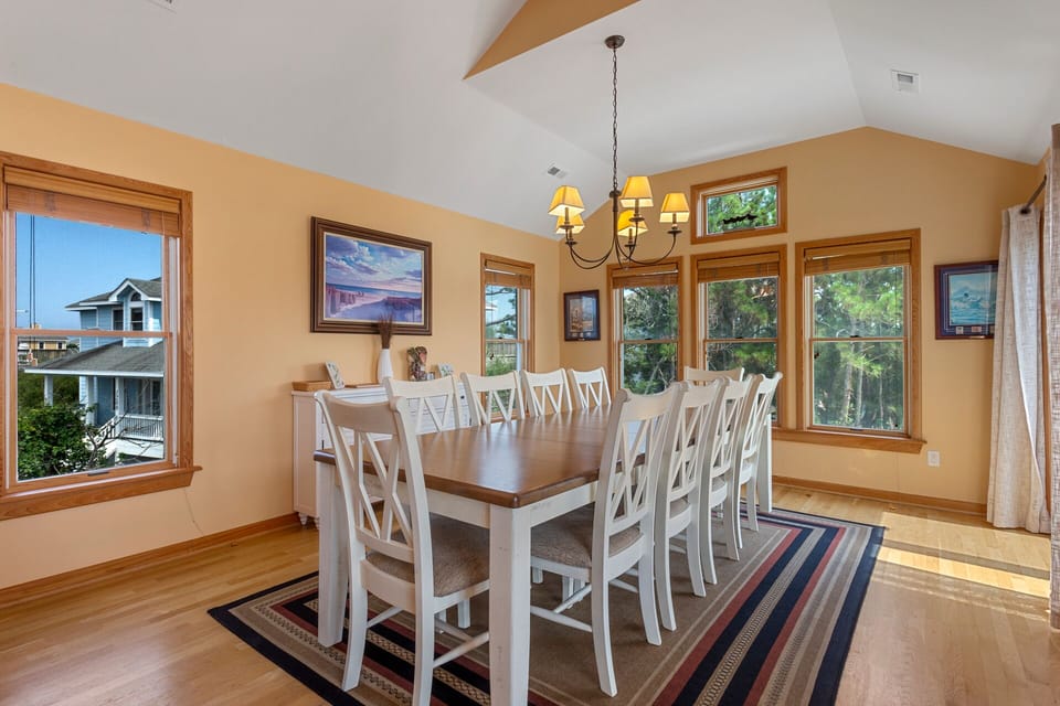 The beautifully-appointed dining area is framed by light-filled windows and elegant decor.