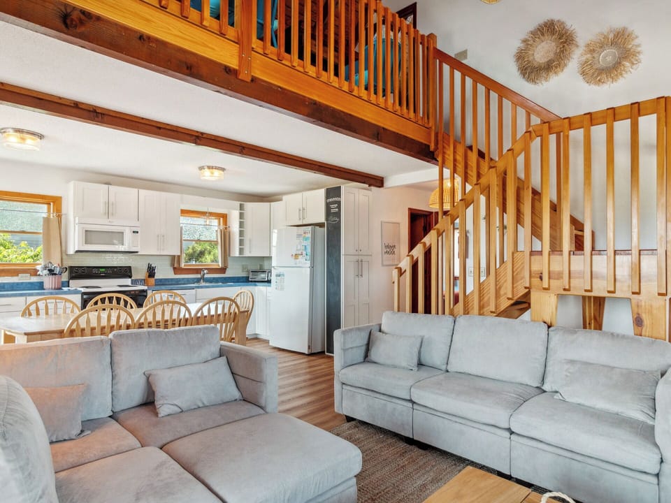 Cozy and bright living space with beach-inspired décor—perfect for movie nights or relaxing after a day in the sand.