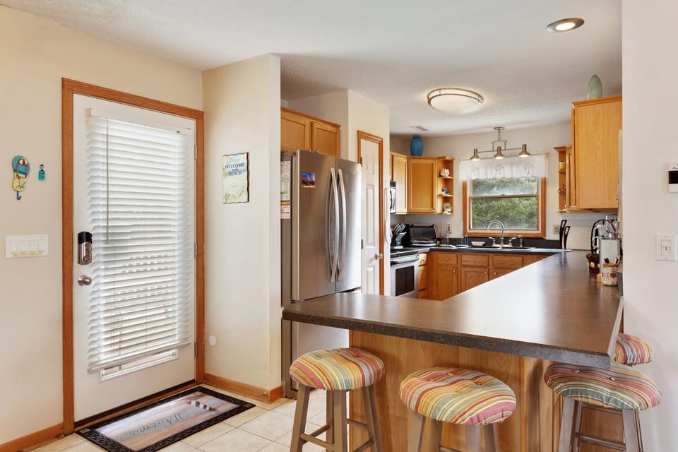 Kitchen: Modern kitchen with stainless steel refrigerator and all the essentials for vacation cooking.