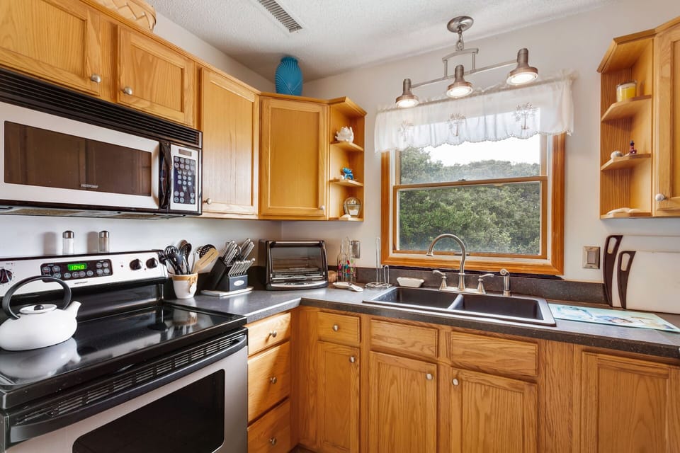 Kitchen: Modern kitchen with stainless steel refrigerator and all the essentials for vacation cooking.