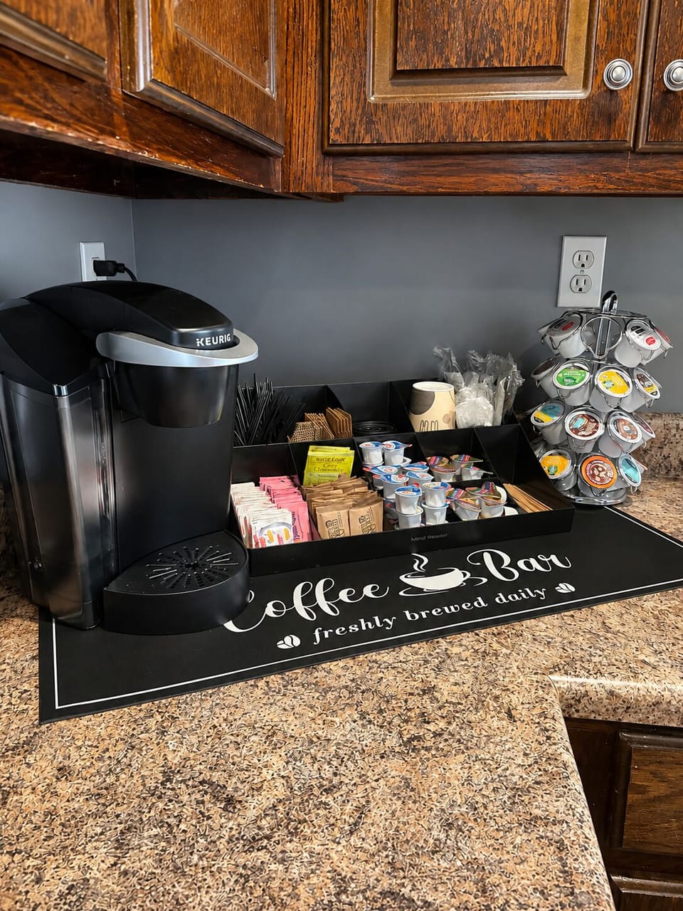 Fully stocked coffee bar, featuring coffee, tea, creamers, and sweeteners. 