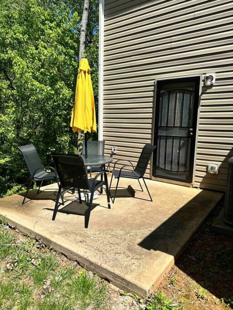Private patio with outdoor dining set and umbrella for al fresco meals and relaxation