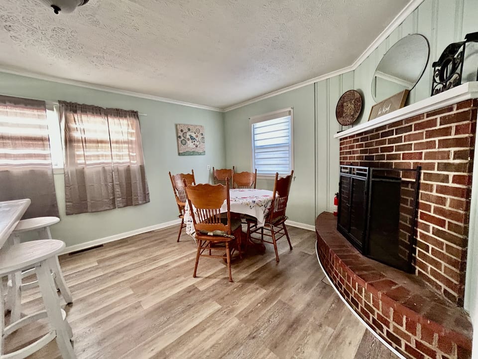 Cozy dining area with working fireplace.