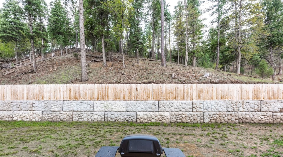 Fenced in backyard with propane grill and hot tub