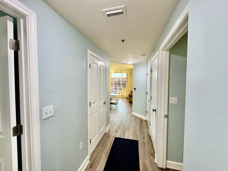 Hallway after entering unit. Bunk room on left, rear king bedroom on the right