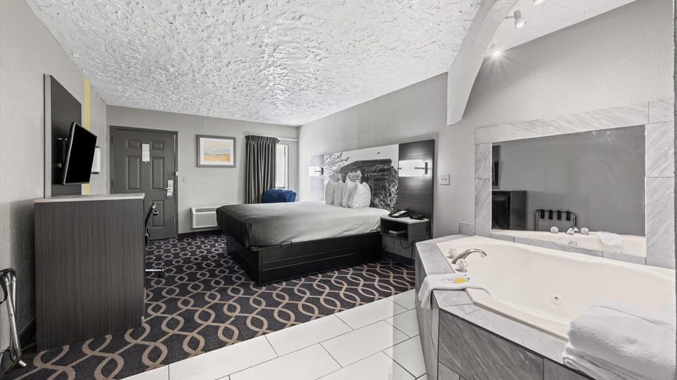 Deluxe Suite, 1 King Bed, Non Smoking | Desk, laptop workspace, blackout drapes, iron/ironing board