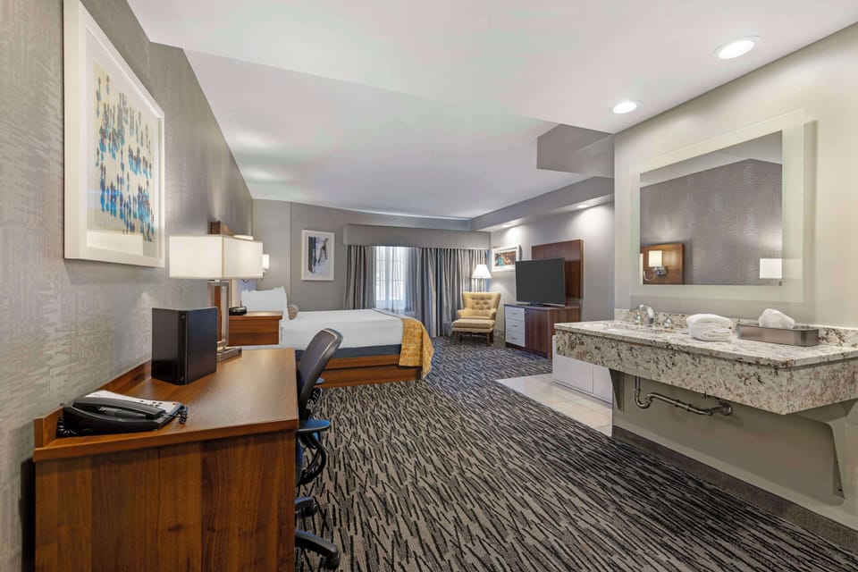 Suite, 1 King Bed, Non Smoking, Jetted Tub | Desk, laptop workspace, blackout drapes, iron/ironing board