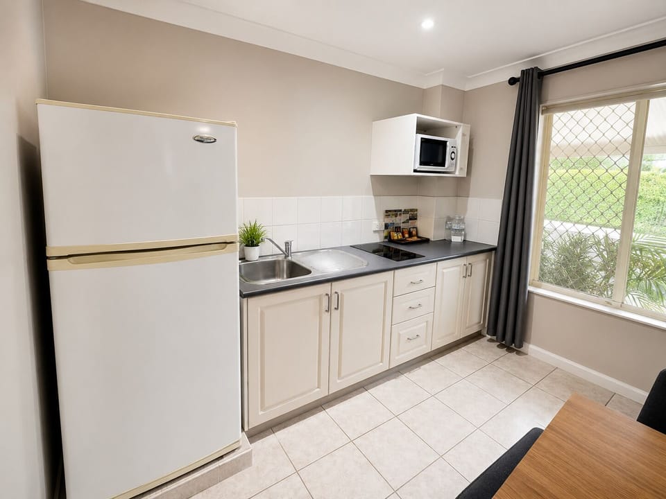 1 Bedroom Apartment | Private kitchen | Coffee/tea maker, mini-fridge, microwave, electric kettle
